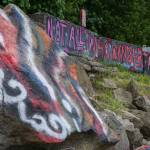 Graffiti dot the boulders and concrete barriers along the shore at Howarth Park in Mukilteo. (Kevin Clark / The Herald)