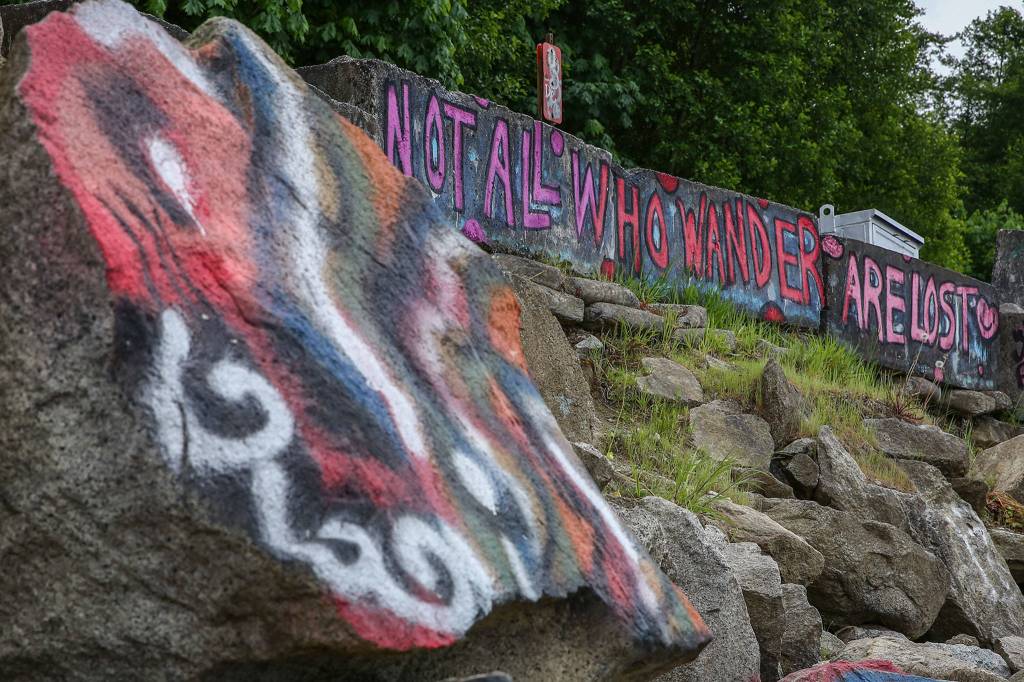 Graffiti dot the boulders and concrete barriers along the shore at Howarth Park in Mukilteo. (Kevin Clark / The Herald)
