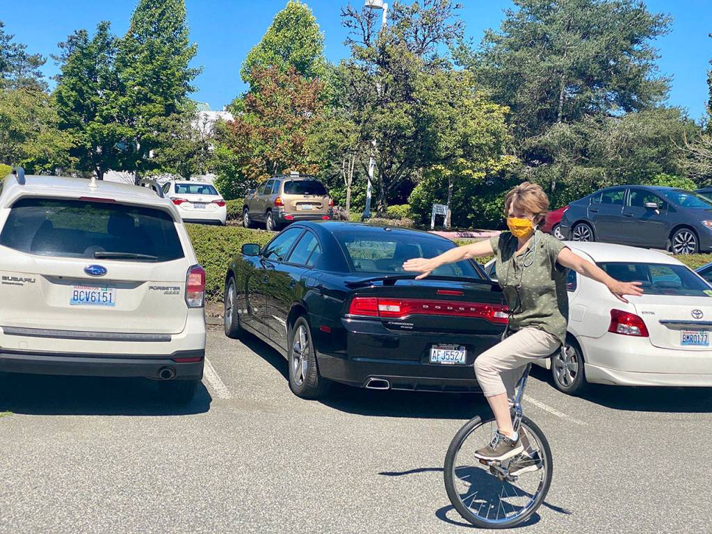 Janice rides her unicycle in the Herald parking lot. (Andrea Brown / The Herald)