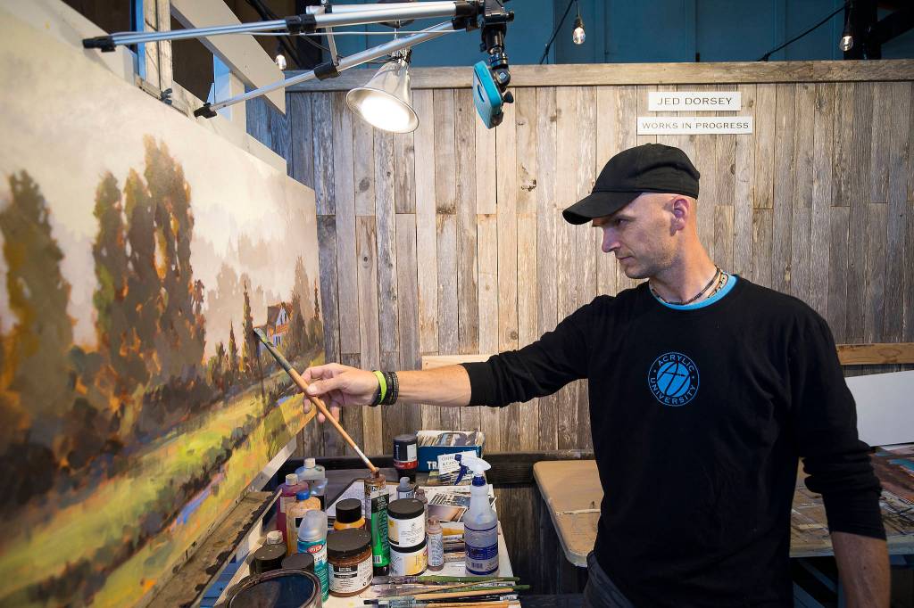 Painter Jed Dorsey works on a piece in the Jed Dorsey Fine Art Studio at Camano Commons. (Andy Bronson / The Herald)