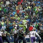 Seahawks fans stand in the rain during the second half of a game against the Ravens on Oct. 20, 2019, in Seattle. (AP Photo/Elaine Thompson)