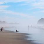 People walk on the beach near the Facebook cable landing site at Tierra del Mar, Oregon, on Aug. 17. (AP Photo/Andrew Selsky)