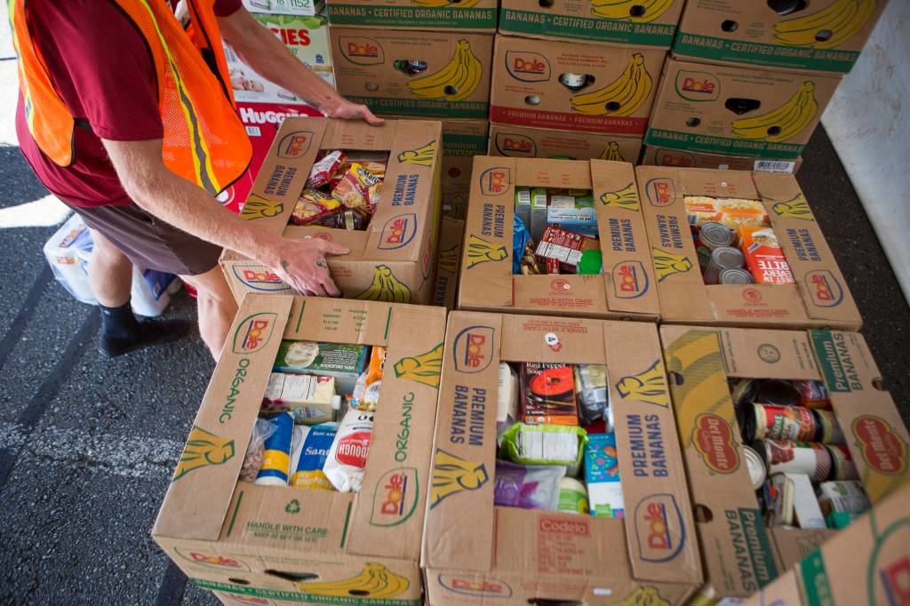 Boxes full of food donations are stacked Thursday during the drive-thru Snohomish County Food Drive in Monroe. (Olivia Vanni / The Herald)