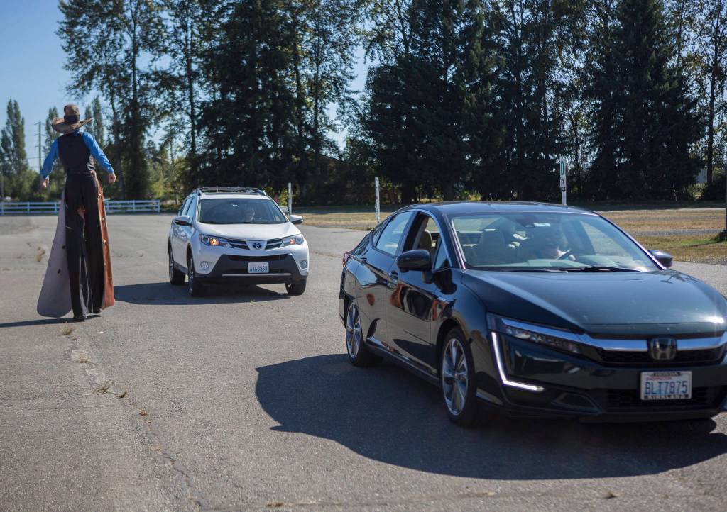 Cars line up Thursday at the Evergreen State Fairgrounds to make donations to the Snohomish County Food Drive in Monroe. (Olivia Vanni / The Herald)