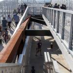 While most people walk down the ramp, a few take the stairs as the Grand Avenue Park Bridge opens for public use Wednesday in Everett. (Andy Bronson / The Herald)