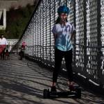 Averyn Radakovic rides her overboard up the ramp as the Grand Avenue Park Bridge opens for public use Wednesday in Everett. (Andy Bronson / The Herald)