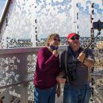 Marianne and Barry McWilliams take a photo together as they walk down the newly opened Grand Avenue Park Bridge on Wednesday in Everett. (Andy Bronson / The Herald)