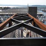 Pedestrians get a higher view of the marina as they walk along the Grand Avenue Park Bridge on Wednesday in Everett. (Andy Bronson / The Herald)