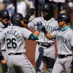 The Mariners Jose Marmolejos (26) is greeted by teammates Austin Nola (left), Kyle Lewis (second from right), and Sam Haggerty after hitting a grand slam during the first inning of a game against the Padres on Aug. 27, 2020, in San Diego. (AP Photo/Gregory Bull)