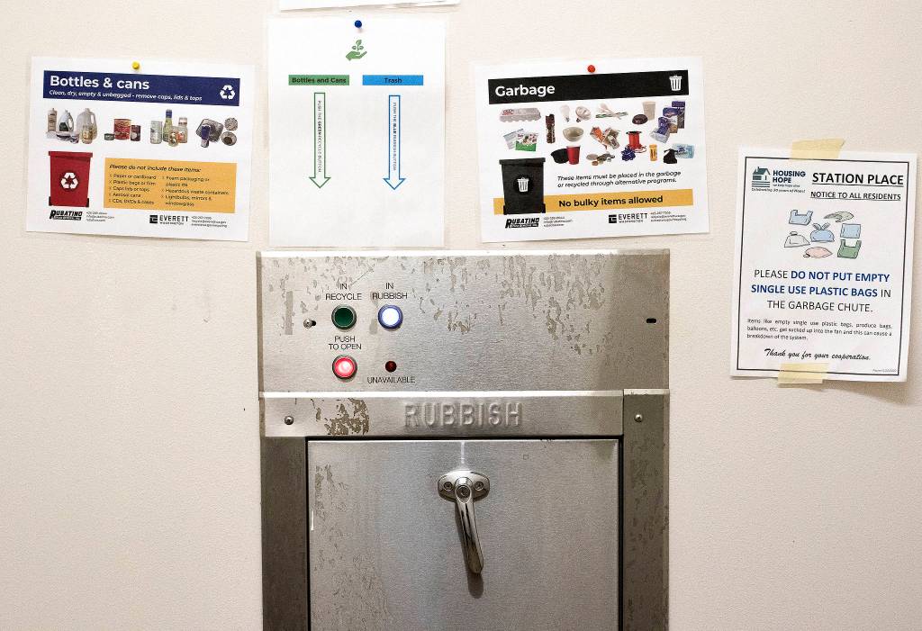 Garbage, recycling and compost are separated by residents by using different buttons for the garbage chute on each level of HopeWorks Station in Everett. (Andy Bronson / The Herald)