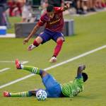 Real Salt Lake midfielder Maikel Chang (above) jumps over Sounders defender Yeimar Gomez during the first half of an MLS match Sept. 2, 2020, in Sandy, Utah. (AP Photo/Rick Bowmer)