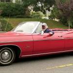 Everetts Jack ODonnell pauses to greet a bystander as he drives up Rucker Avenue during Saturdays informal cruise. (Julie Muhlstein / The Herald)