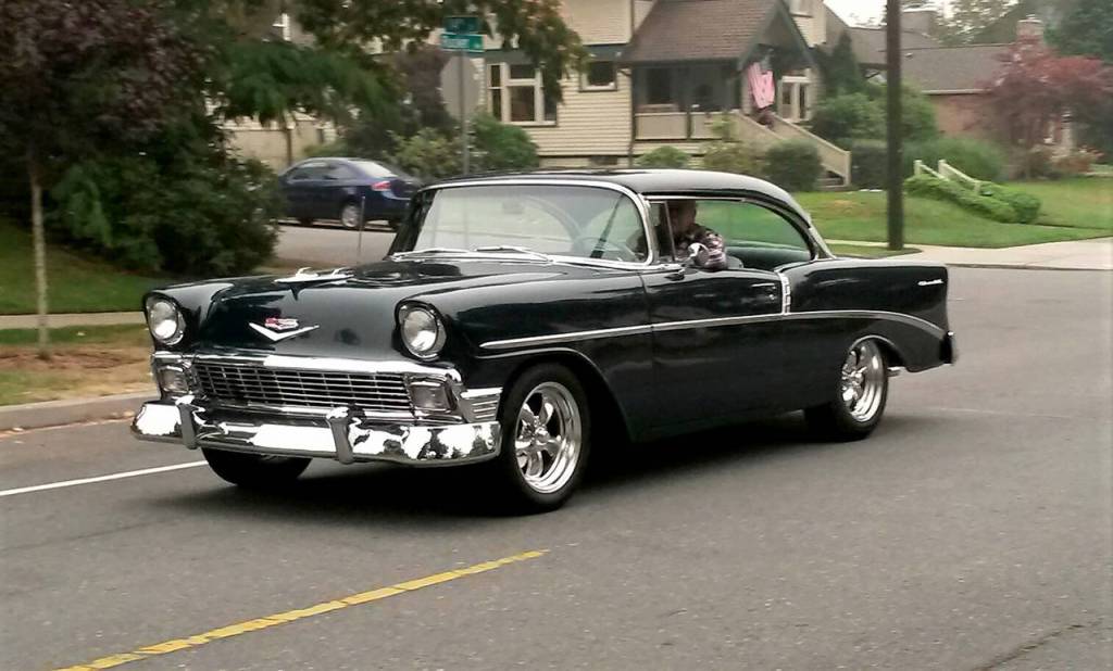 A shiny black Chevy brings the 1950s back to Rucker Avenue in north Everett as its driver joins Saturdays informal cruise. (Julie Muhlstein / The Herald)