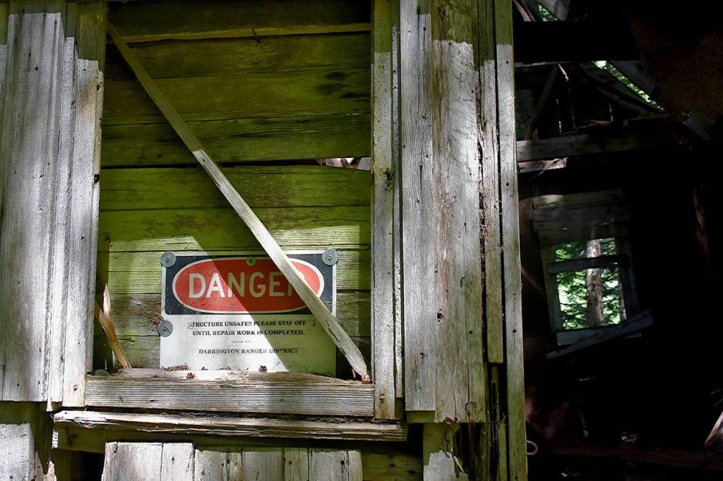 A sign warns of danger at the Monte Cristo townsite in 2018. (Caleb Hutton / Herald file)