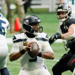 Seattle Seahawks quarterback Russell Wilson looks for a receiver against the Atlanta Falcons during the first half of an NFL football game Sunday in Atlanta. (AP Photo/Brynn Anderson)