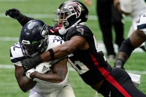 Seattle Seahawks running back Chris Carson (32) is tackled by Atlanta Falcons defensive end Dante Fowler Jr. (56) during the first half of Sundays game in Atlanta. (AP Photo/John Bazemore)