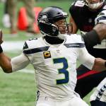 Seattle Seahawks quarterback Russell Wilson throws a pass in the first half against Atlanta on Sunday. He went an eye-popping 31 for 35 for the game. (Associated Press)