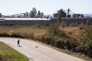 A man operates a radio-controlled car on a street near the Bay Wood property on Monday, Sept. 28, 2020 in Everett, Washington. The  Port of Everett is set to clean up the Bay Wood property, which lies along the northern end of West Marine Drive near Maulsby Mudflats where the Snohomish River and Port Gardner Bay meet. (Andy Bronson / The Herald)