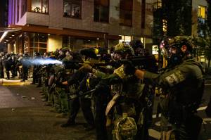 Federal police try to take control of the streets during protests, Friday, Sept. 18, 2020, in Portland, Ore. (AP Photo/Paula Bronstein)