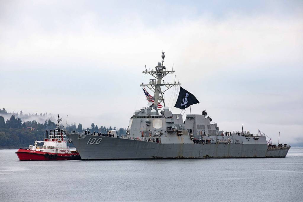 The USS Kidd pulls into its homeport at Naval Station Everett Monday morning, flying a Jolly Roger flag. Dozens on the ship contracted COVID-19 during the nearly nine-month long deployment. (U.S. Navy photo by Mass Communication Specialist 3rd Class Ethan Soto/Released)