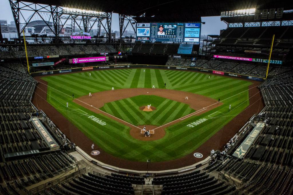 Mariners pitcher Nick Margevicius throws out the first pitch of the Mariners final home game of the season in an empty T-Mobile Park filled with cutouts on Wednesday, Sept. 23, 2020, in Seattle. (Olivia Vanni / The Herald)