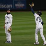 The Mariners J.P. Crawford watches as teammate Dee Strange-Gordon makes a catch during a game against the Astros on Wednesday, Sept. 23, 2020, in Seattle. (Olivia Vanni / The Herald)