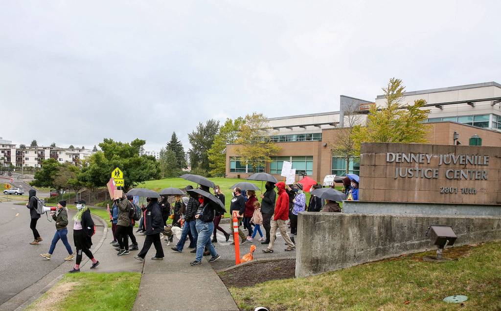 Protesters march to push reforms Saturday outside Denney Juvenile Justice Center in Everett. (Kevin Clark / The Herald)