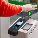 This undated photo provided by Amazon shows the Amazon One device at an Amazon Go store in Seattle. Amazon has introduced the new palm recognition technology in a pair of Seattle stores and sees broader uses in places like stadiums and offices.  Customers at the stores near Amazon's campus in Washington can flash a palm for entry and to buy goods. (Amazon via AP)