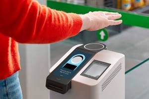 This undated photo provided by Amazon shows the Amazon One device at an Amazon Go store in Seattle. Amazon has introduced the new palm recognition technology in a pair of Seattle stores and sees broader uses in places like stadiums and offices.  Customers at the stores near Amazon's campus in Washington can flash a palm for entry and to buy goods. (Amazon via AP)