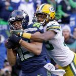 Seattle Seahawks' Jermaine Kearse catches the game-winning touchdown pass in front of Green Bay Packers' Tramon Williams during overtime of the NFL football NFC Championship game Sunday, Jan. 18, 2015, in Seattle. The Seahawks won 28-22 to advance to Super Bowl XLIX. (AP Photo/David J. Phillip)