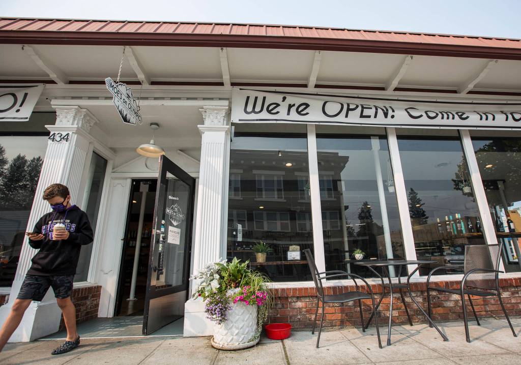 A customer walks out of Moes on Olympic on Sept. 30 in Arlington. It offers socially distanced outdoor seating and requires a mask and social distancing upon entry. (Olivia Vanni / The Herald)