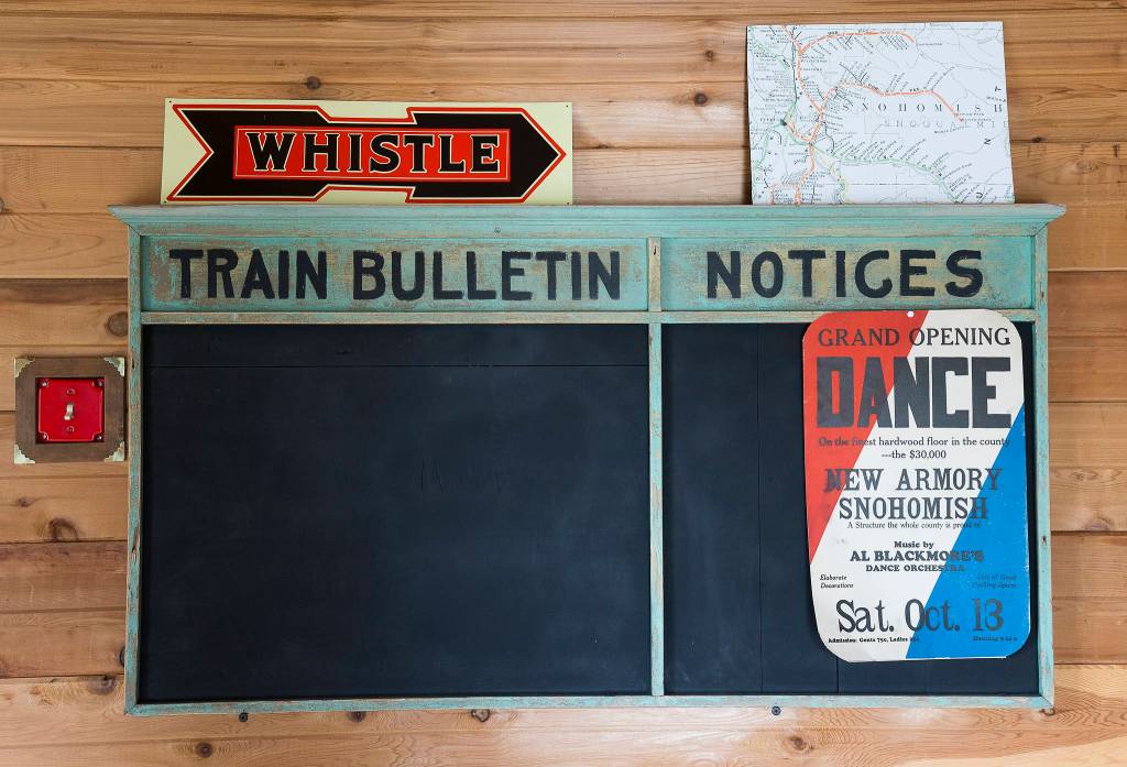 An original train bulletin board hangs in a freight room of the home of Bruce and Marie Ferguson in Snohomish. The Fergusons built in their home in 2007 to mimic a Northern Pacific train depot. (Andy Bronson / The Herald)