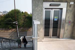 A couple takes the stairs near the Grand Avenue Park Bridge elevator on Wednesday, Sept. 30, 2020 in Everett, Washington.  The elevator was out of service for a couple of days when the door was damaged between the evening of Sept. 18 and morning of Sept. 19. (Andy Bronson / The Herald)
