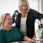 Founding member Janet Bacon pours champagne for Kit Massengale in a 2019 celebration of the formation of the new Snohomish County chapter of 100+ Women Who Care. Despite the pandemic, the group is ready to choose another organization to support. (Kevin Clark / The Herald)