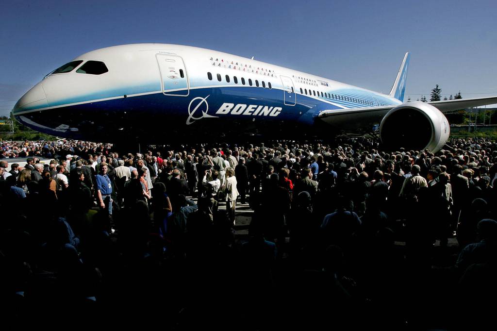 The first Boeing 787 is swarmed by the crowd attending the rollout of the plane at the Boeing assembly facilty on July 8, 2007. (Michael OLeary / Herald file)