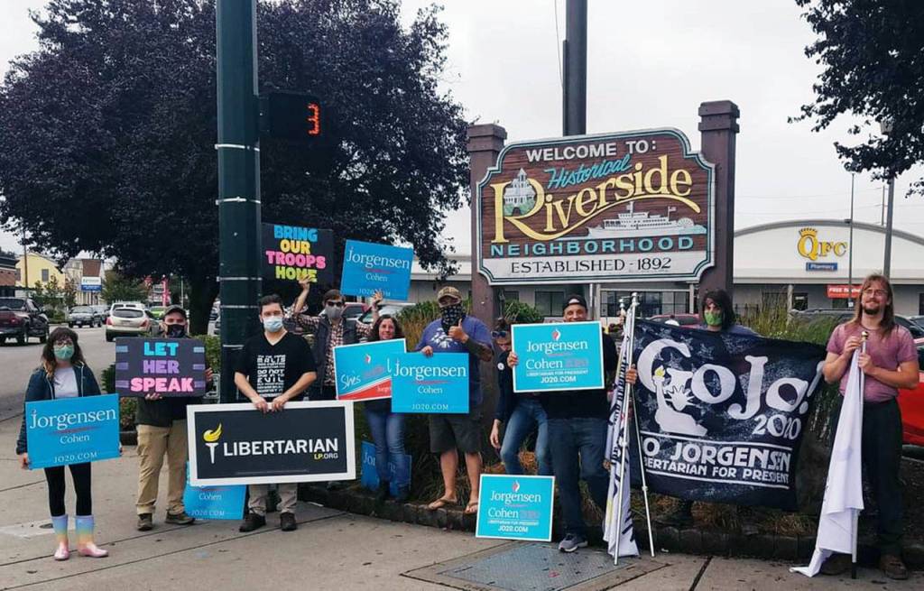 Supporters of Libertarian Party presidential candidate Jo Jorgensen wave signs in Everett. (Layla Bush)