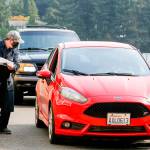 Bryan Robbins check off students picking up equipment class at Meadowdale High School in Lynnwood on Oct. 1, 2020. (Kevin Clark / The Herald)