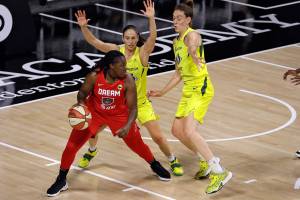 Atlanta Dream forward Shekinna Stricklen (40) dribbles in front of Seattle Storm guard Sue Bird (10) and forward Breanna Stewart (30) during the first half of a WNBA basketball game Wednesday, Aug. 12, 2020, in Bradenton, Fla. (AP Photo/Chris O'Meara)