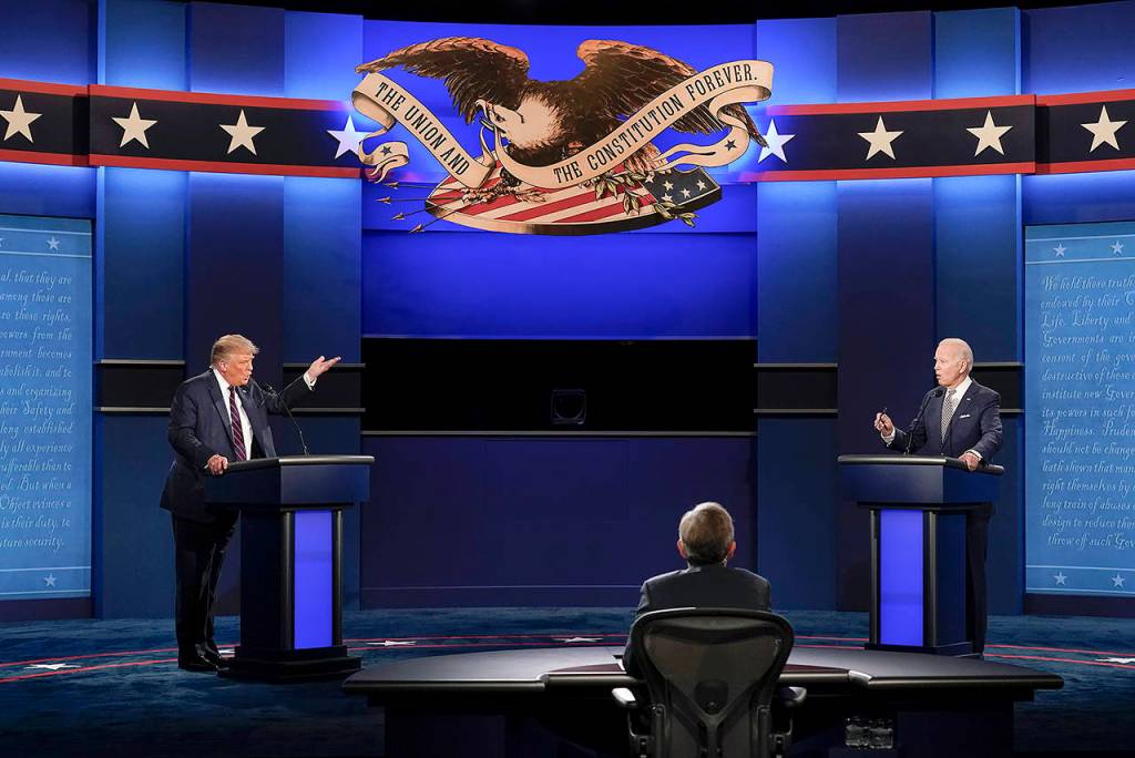 President Donald Trump (left) and Democratic presidential candidate former Vice President Joe Biden (right) stood about 10 feet apart during the first presidential debate Tuesday at Case Western University and Cleveland Clinic, in Cleveland, Ohio. Seated in the center is moderator Chris Wallace of Fox News. (AP Photo/Patrick Semansky)
