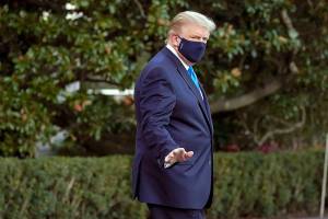 President Donald Trump waves to members of the media as he leaves the White House to go to Walter Reed National Military Medical Center after he tested positive for COVID-19, Friday, Oct. 2, 2020, in Washington. (AP Photo/Alex Brandon)