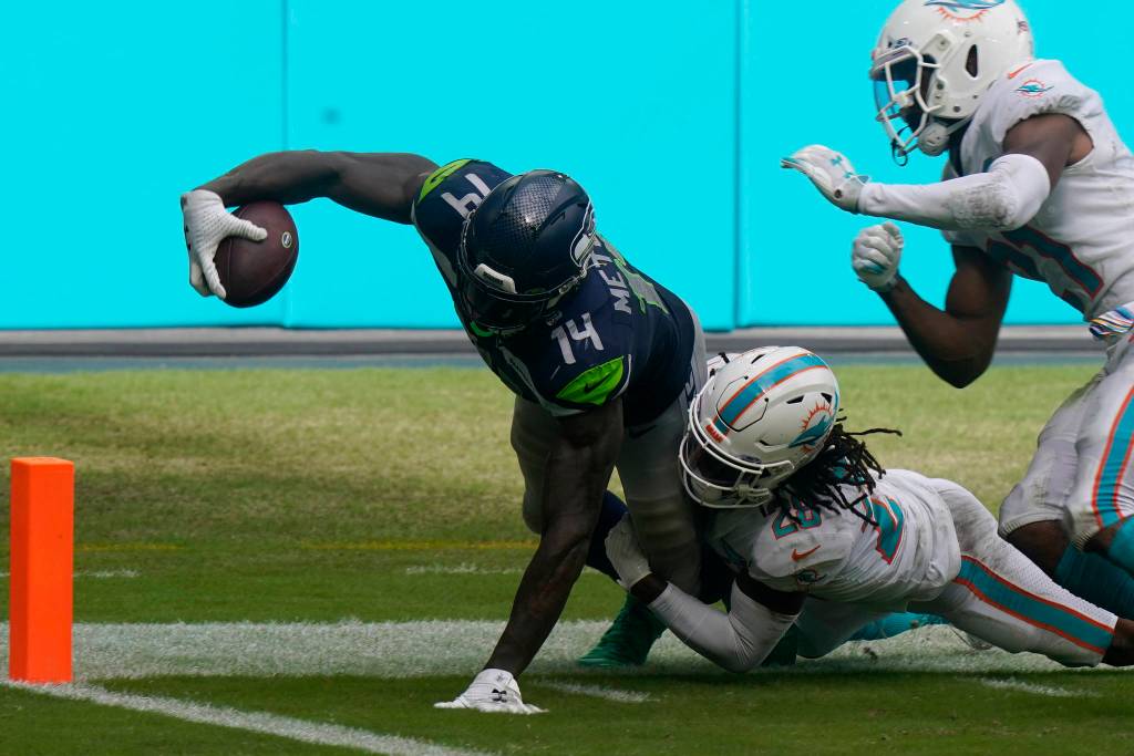 Miami Dolphins strong safety Bobby McCain (28) takes Seattle Seahawks wide receiver DK Metcalf (14) near the end zone, during the second half of an NFL football game, Sunday, Oct. 4, 2020, in Miami Gardens, Fla. (AP Photo/Lynne Sladky)