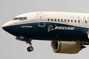 FILE  - In this Sept. 30, 2020, file photo, a Boeing 737 MAX jet, piloted by Federal Aviation Administration (FAA) chief Steve Dickson, prepares to land at Boeing Field following a test flight in Seattle. Boeing says the pandemic will reduce demand for new planes for the next decade, long after experts expect a vaccine for COVID-19. The company updated its forecast of the airplane market on Tuesday, Oct. 6, 2020. It remains upbeat about long-term prospects driven by increasing air travel in Asia. Boeing, which along with Europe’s Airbus dominates the aircraft-building industry, has seen orders and deliveries of new planes crumble this year. (AP Photo/Elaine Thompson, File)