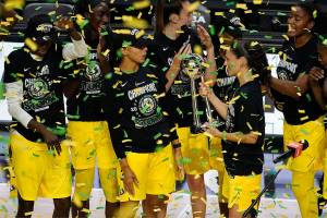 Seattle Storm guard Sue Bird shows the trophy to some of her teammates after the team defeated the Las Vegas Aces to win the WNBA championship Tuesday, Oct. 6, 2020, in Bradenton, Fla. (AP Photo/Chris O'Meara)
