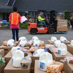 Volunteers await the next grouping a cars Friday morning at the Faith Food Bank at Faith Lutheran Church in Everett on October 9, 2020.   (Kevin Clark / The Herald)