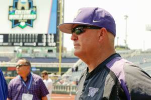Washington coach Lindsay Meggs follows team practice at TD Ameritrade Park in Omaha, Neb., Friday, June 15, 2018. Washington plays Mississippi State on Saturday in the NCAA College World Series baseball tournament.. (AP Photo/Nati Harnik)