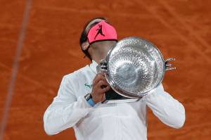 Spain's Rafael Nadal holds the trophy as he celebrates winning the final match of the French Open tennis tournament against Serbia's Novak Djokovic in three sets, 6-0, 6-2, 7-5, at the Roland Garros stadium in Paris, France, Sunday, Oct. 11, 2020. (AP Photo/Alessandra Tarantino)