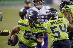 Seattle Seahawks linebacker K.J. Wright runs with the ball after recovering a Minnesota Vikings fumble during the second half of Sunday nights game at CenturyLink Field. (AP Photo/Ted S. Warren)
