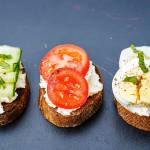 crostini with ricotta and fillings on a black background. the toning. selective focus.
