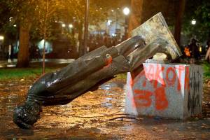 A group of protesters toppled statues of former presidents Theodore Roosevelt and Abraham Lincoln in Portland's South Park Block late Sunday, Oct. 11, 2020. (Sean Meagher/The Oregonian via AP)