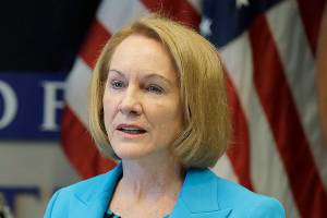 Seattle Mayor Jenny Durkan, right, speaks, Monday, July 13, 2020, during a news conference at City Hall in Seattle. Durkan and Police Chief Carmen Best, looking on at left, were critical of a plan backed by several city council members that seeks to cut the police department's budget by 50 percent. (AP Photo/Ted S. Warren)